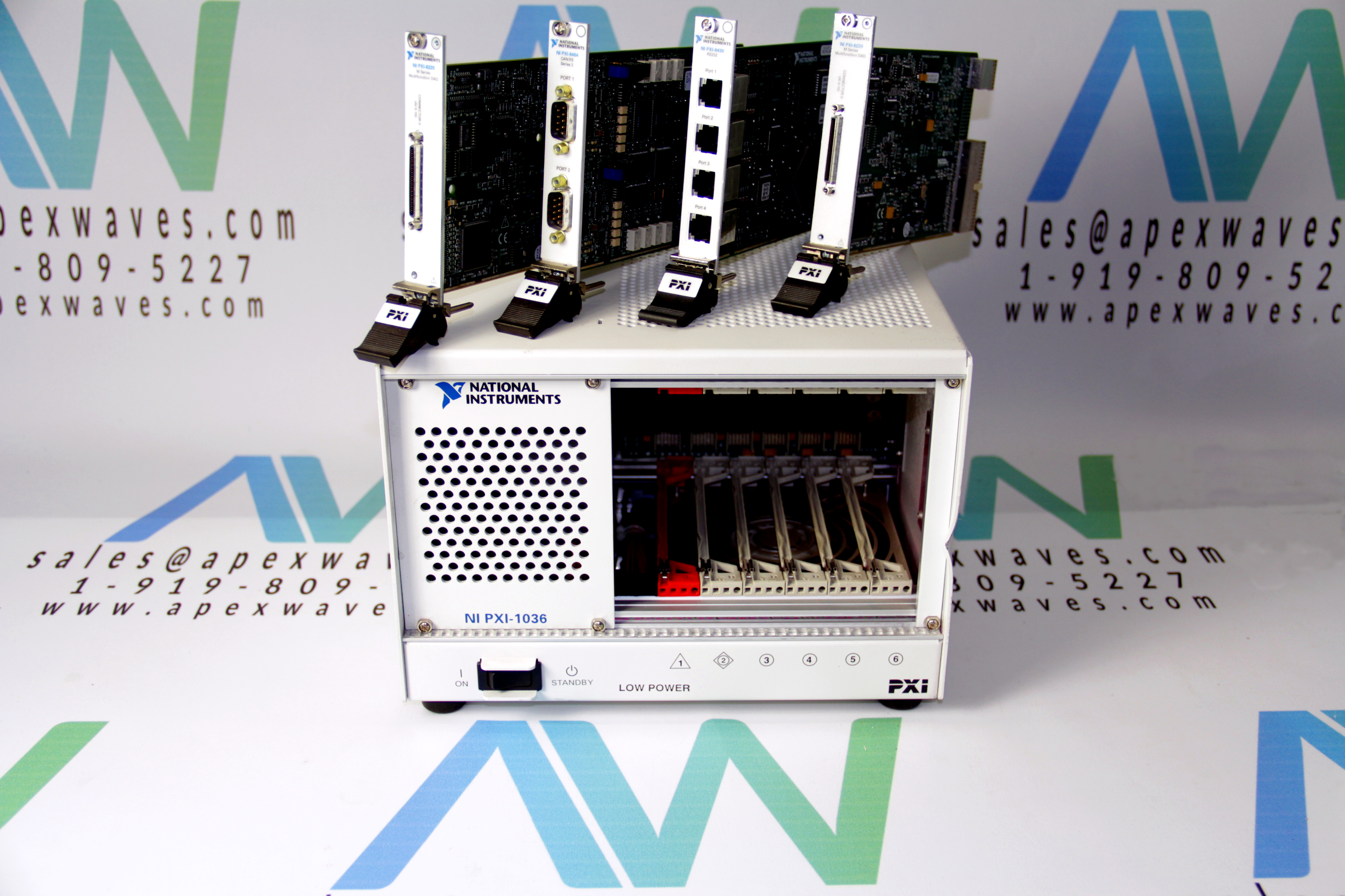 4 PXI cards on top of a PXI-1036 Chassis from NI with an Apex Waves logo backdrop