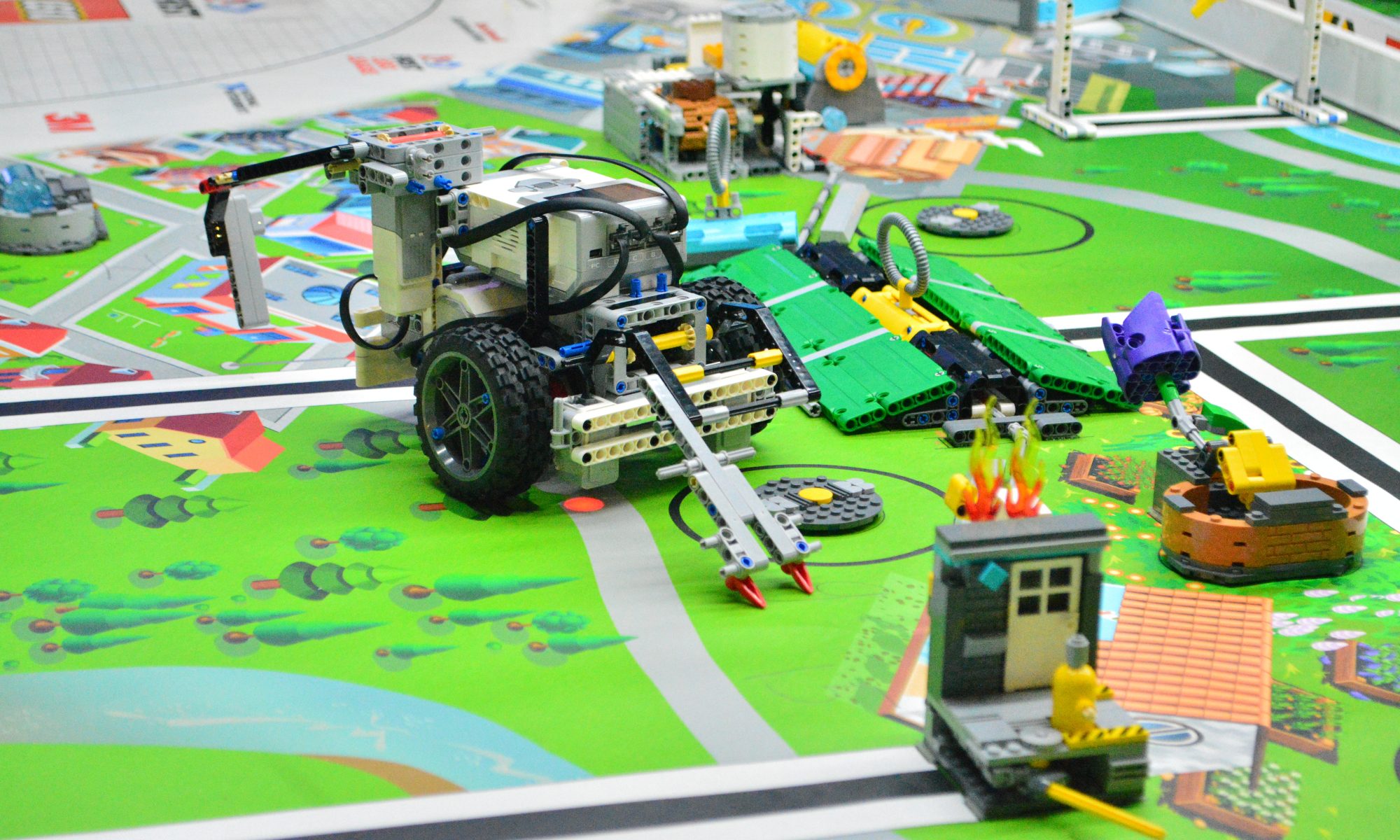 Lego Robot and assorted pieces on a play mat