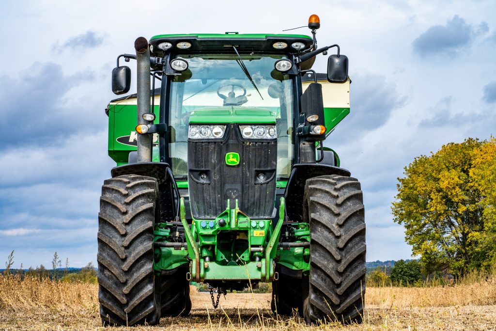 Front view of a green John Deere tractor in a field