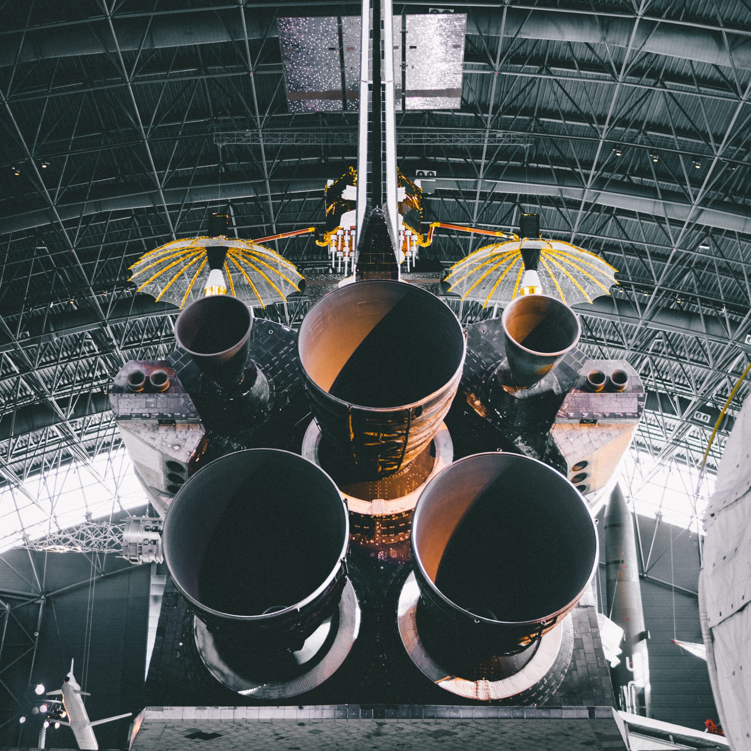 Closeup to back of shuttle engines in a warehouse