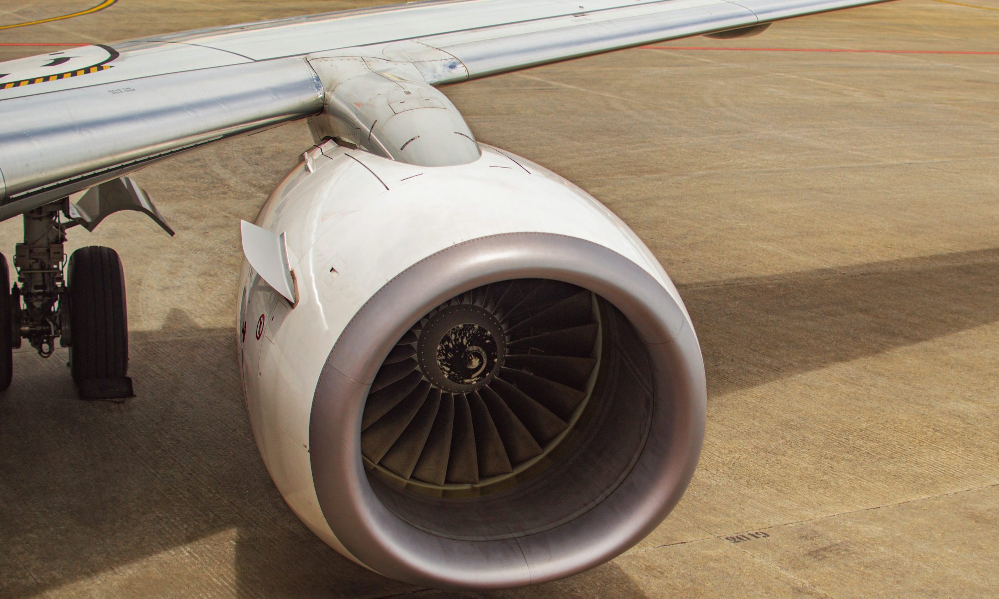 Birds eye view of white left jet engine on a plane