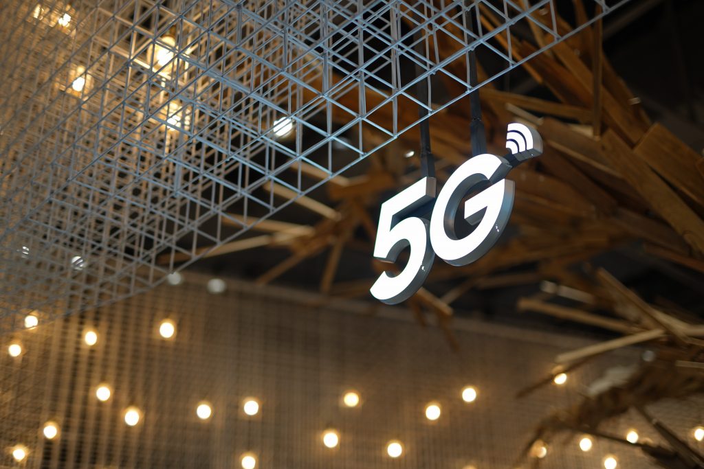 White 5G sign hanging from roof