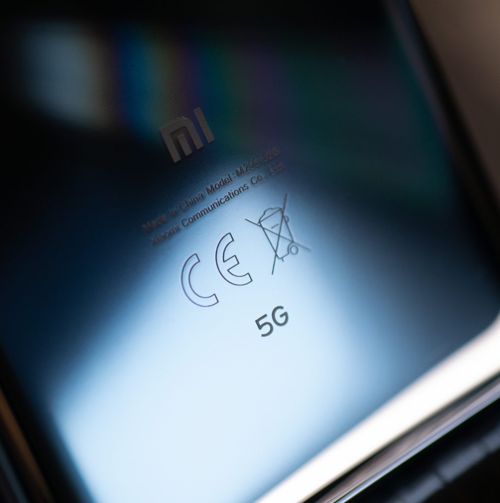 Closeup of 5G symbol on back of a black smartphone