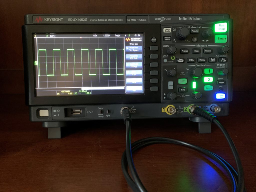 Black Keysight oscilloscope with a square wave on the screen