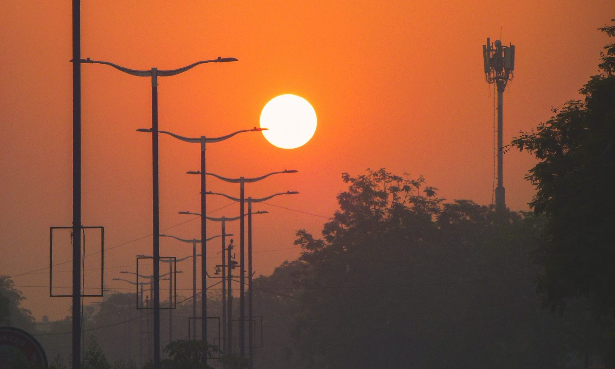 street lamps lining the street in India at sundown