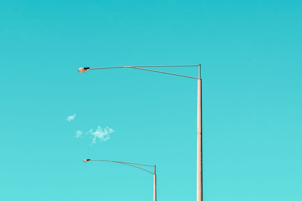 white street lamps against a blue sky