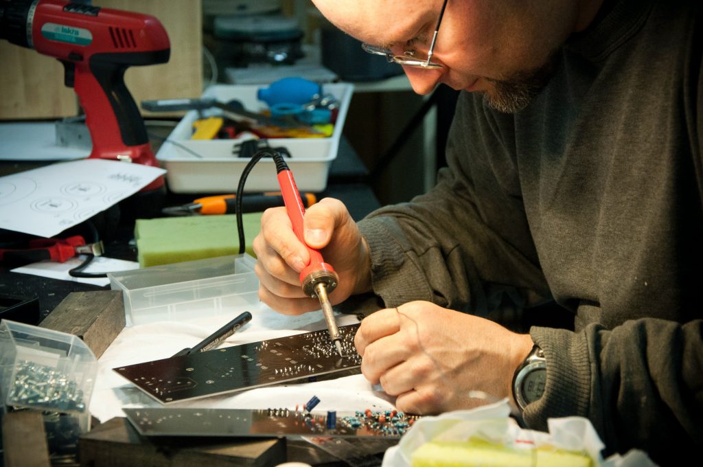 closeup of Man Soldering Circuit Board