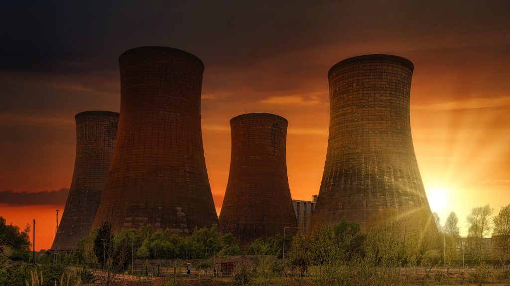 Huge cooling towers in nuclear power plant at sunset