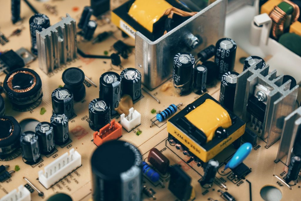 Black Transistor Beside Capacitor on a circuit board