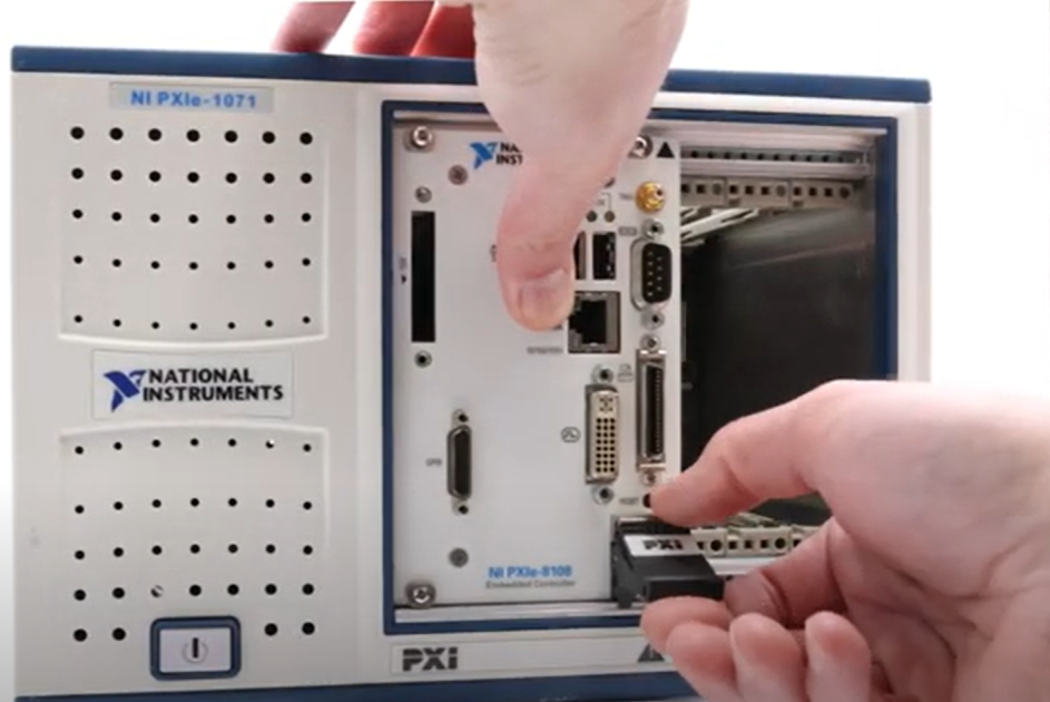 Hands putting a NI module into a chassis
