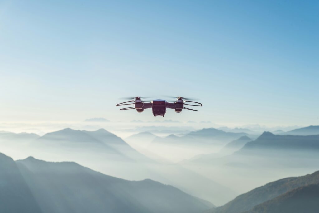 Modernized drone in sky above mountains