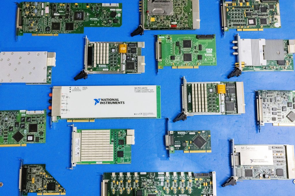 Various NI parts and models on a blue background
