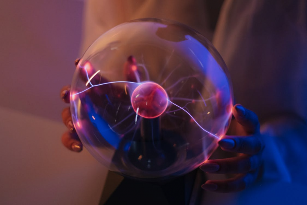 Woman using plasma ball to demonstrate electromagnetism