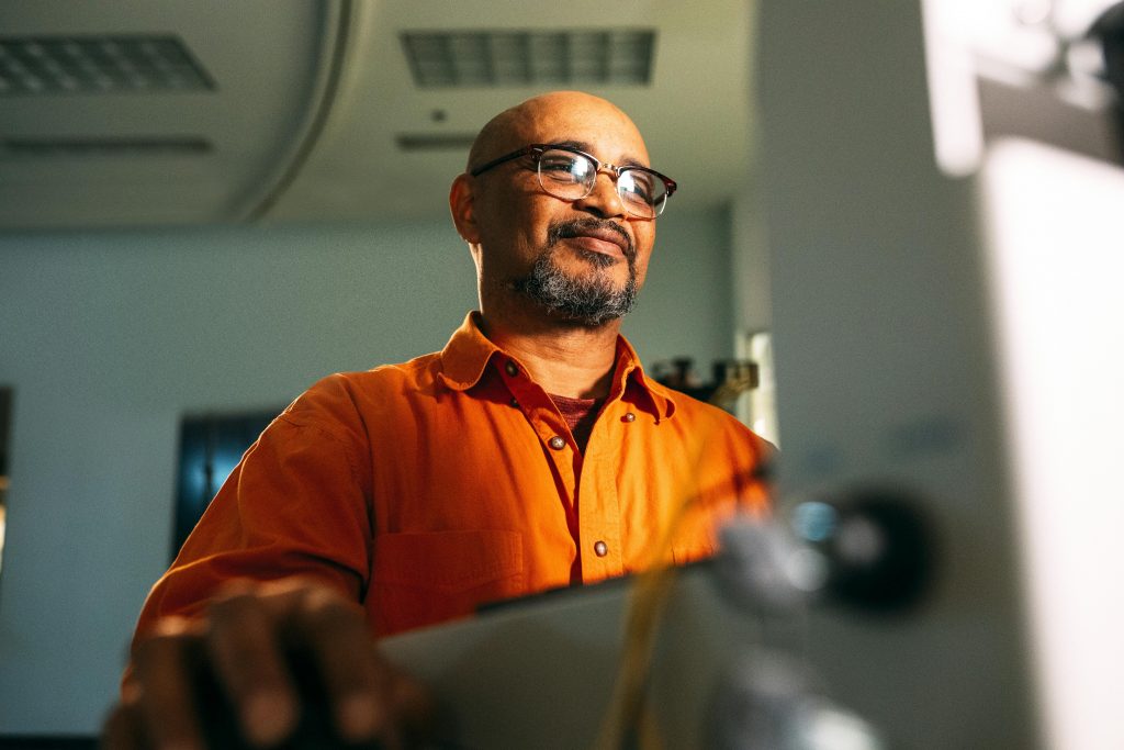 Engineer smiling as he uses a computer