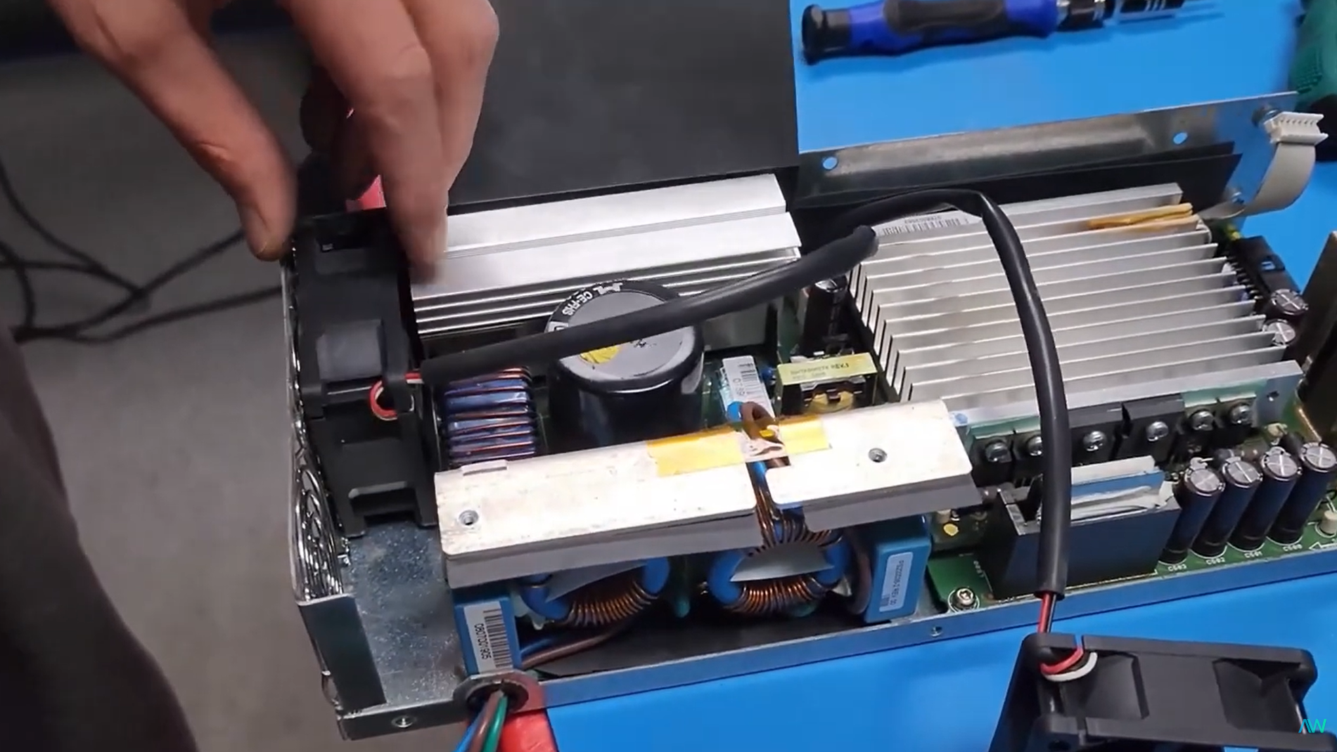 Apex Waves technician repairing a PXI chassis