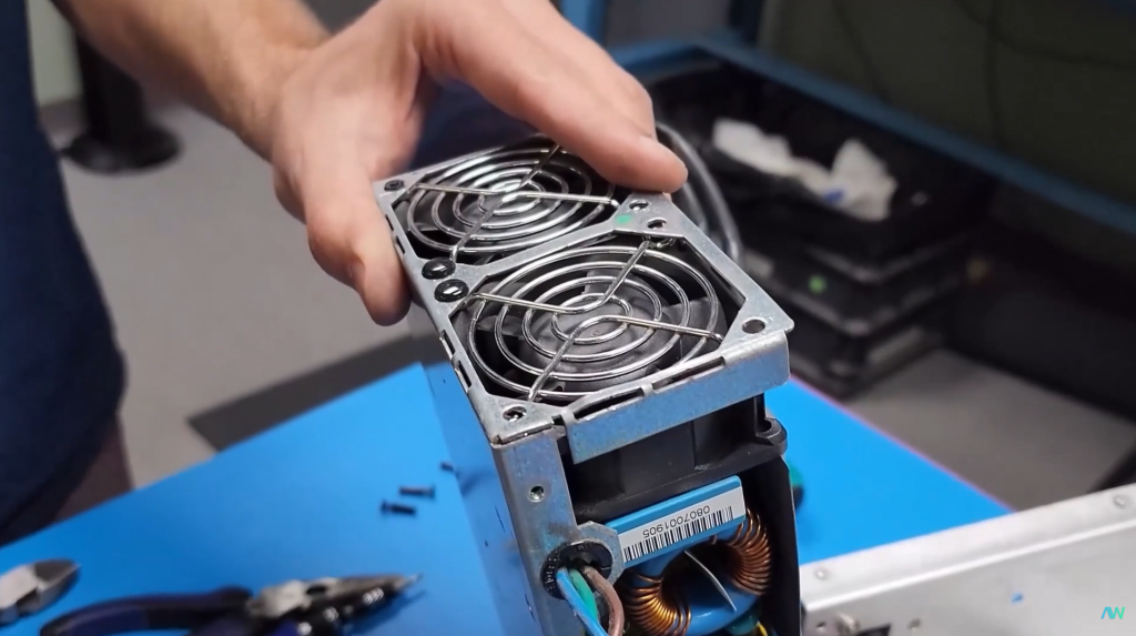 Closeup of technician replacing the fans of a PXI chassis