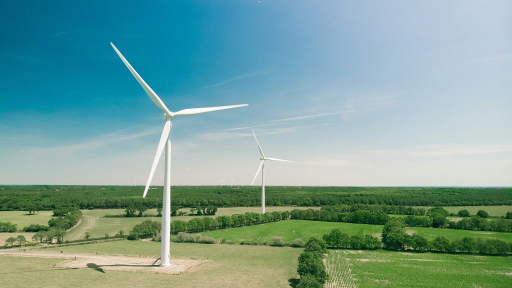White wind turbines in a field