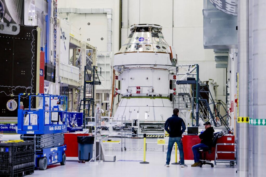 NASA Technicians install Solar Array wings to the Artemis II Orion spacecraft